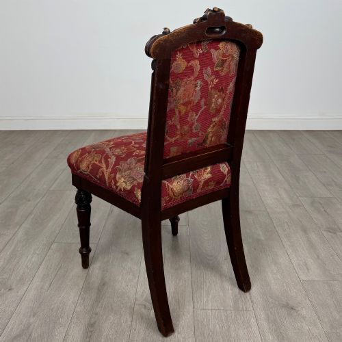 fig 2. A set of six antique 19th-century Victorian oak dining chairs featuring carved crest rails and red patterned fabric upholstery.