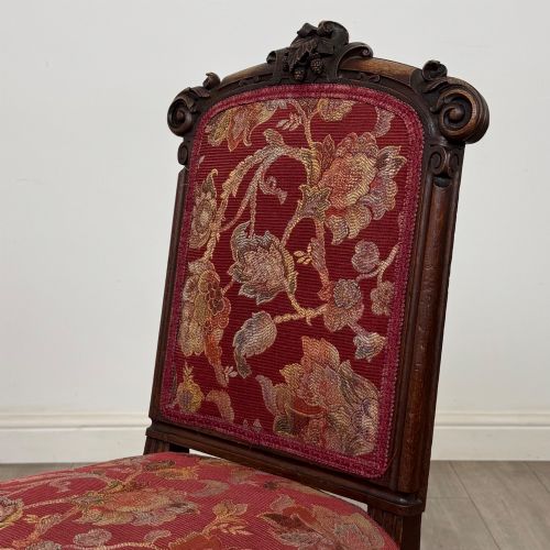 fig 3. A set of six antique 19th-century Victorian oak dining chairs featuring carved crest rails and red patterned fabric upholstery.