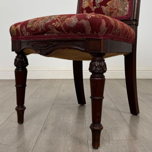 fig 4. A set of six antique 19th-century Victorian oak dining chairs featuring carved crest rails and red patterned fabric upholstery.