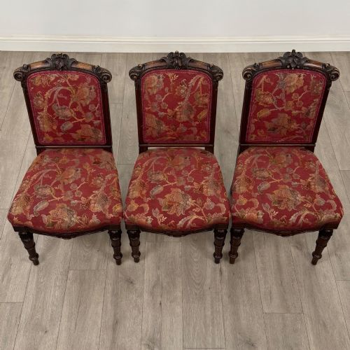 fig 6. A set of six antique 19th-century Victorian oak dining chairs featuring carved crest rails and red patterned fabric upholstery.