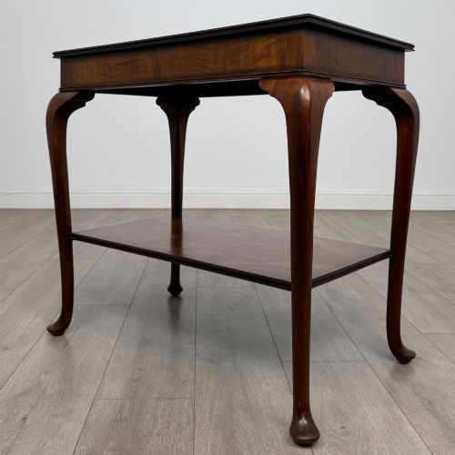 fig 1. An Edwardian burr walnut side table featuring sloped cabriole legs, pad feet, a deep frieze, and a lower undertier shelf.