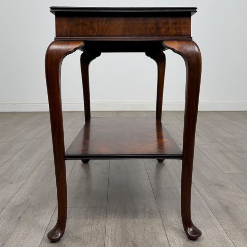 fig 2. An Edwardian burr walnut side table featuring sloped cabriole legs, pad feet, a deep frieze, and a lower undertier shelf.