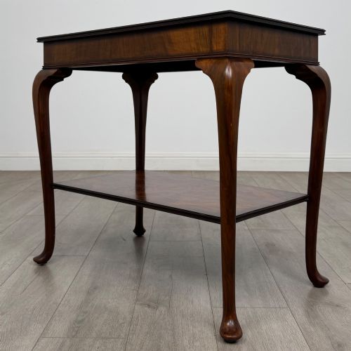 fig 5. An Edwardian burr walnut side table featuring sloped cabriole legs, pad feet, a deep frieze, and a lower undertier shelf.