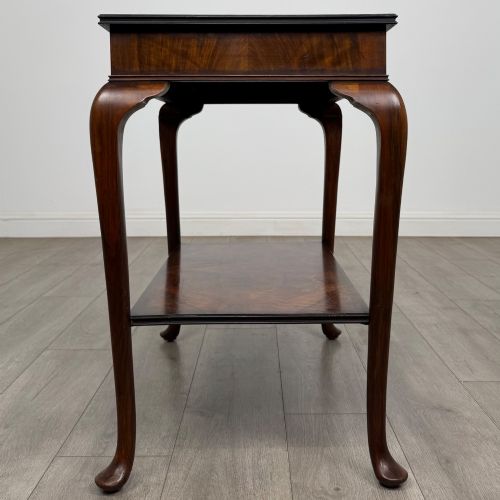 fig 6. An Edwardian burr walnut side table featuring sloped cabriole legs, pad feet, a deep frieze, and a lower undertier shelf.