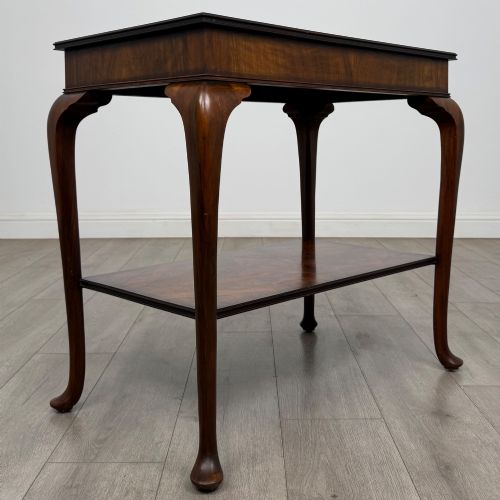 fig 7. An Edwardian burr walnut side table featuring sloped cabriole legs, pad feet, a deep frieze, and a lower undertier shelf.