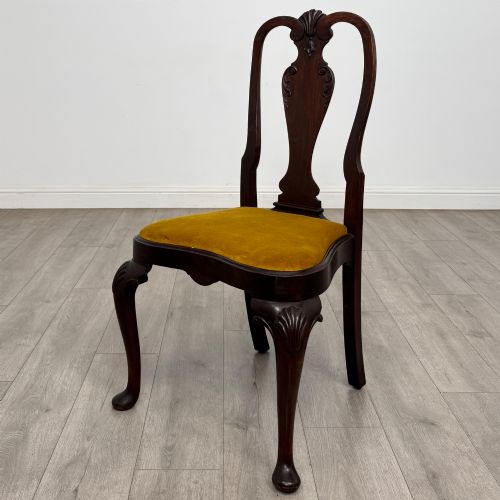 fig 2. A set of six dark mahogany dining chairs featuring cabriole legs, carved back splats, and gold velvet drop-in seats.