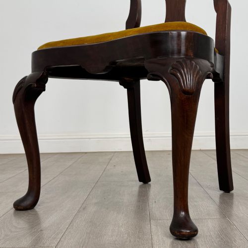 fig 5. A set of six dark mahogany dining chairs featuring cabriole legs, carved back splats, and gold velvet drop-in seats.