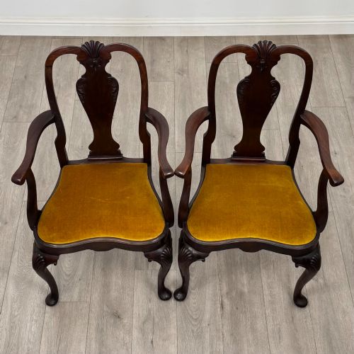 fig 7. A set of six dark mahogany dining chairs featuring cabriole legs, carved back splats, and gold velvet drop-in seats.