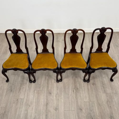 fig 8. A set of six dark mahogany dining chairs featuring cabriole legs, carved back splats, and gold velvet drop-in seats.