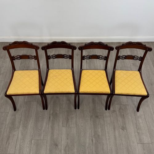fig 2. A set of ten mahogany Regency style dining chairs with yellow upholstered seats, including eight side chairs and two carvers with scrolling arms.
