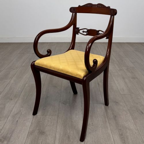 fig 4. A set of ten mahogany Regency style dining chairs with yellow upholstered seats, including eight side chairs and two carvers with scrolling arms.