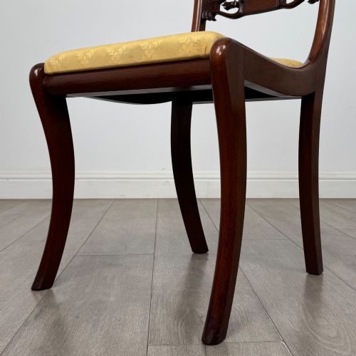 fig 7. A set of ten mahogany Regency style dining chairs with yellow upholstered seats, including eight side chairs and two carvers with scrolling arms.