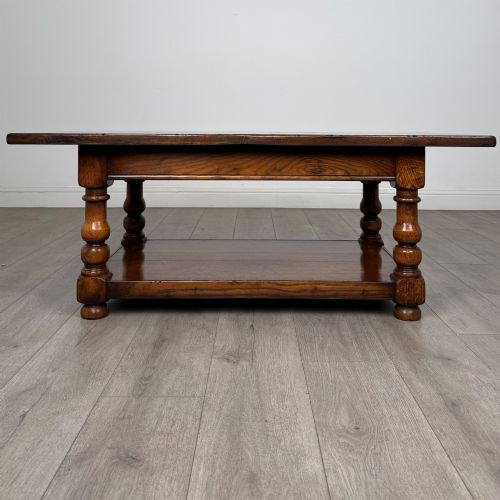 fig 4. A rectangular dark oak coffee table featuring turned baluster legs and a full-length lower shelf.