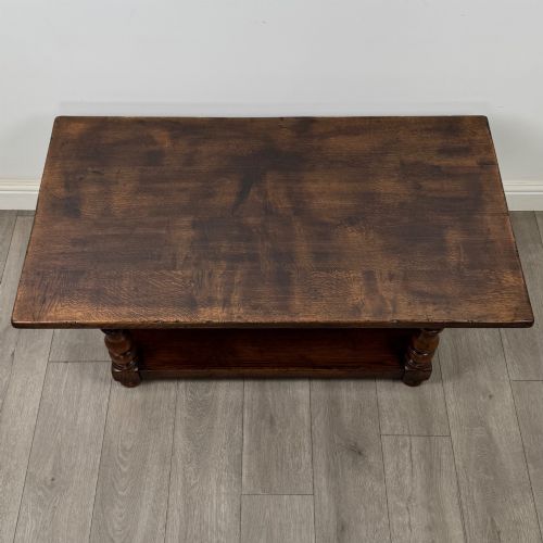 fig 8. A rectangular dark oak coffee table featuring turned baluster legs and a full-length lower shelf.