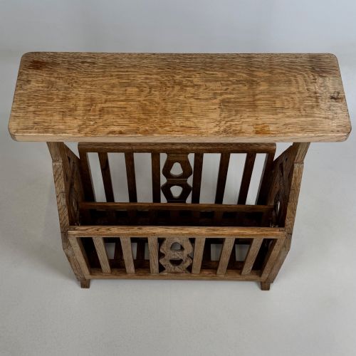 fig 8. An antique Arts and Crafts oak side table featuring a rectangular top supported by slender uprights above a slatted lower magazine trough.