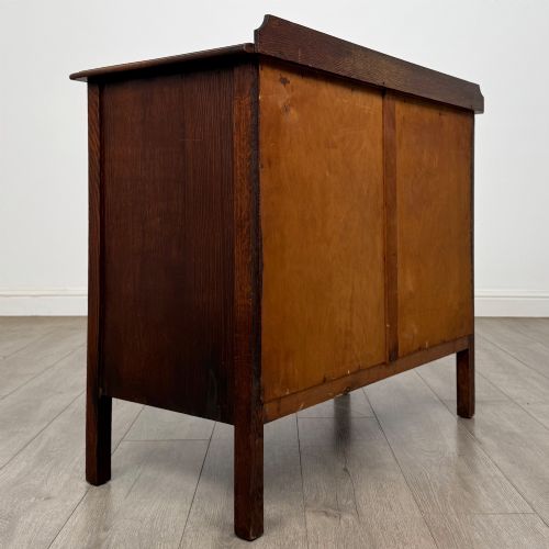 fig 3. An Edwardian oak chest of drawers featuring three full-width drawers with circular pull handles, supported by straight square legs.
