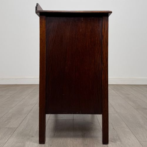 fig 6. An Edwardian oak chest of drawers featuring three full-width drawers with circular pull handles, supported by straight square legs.