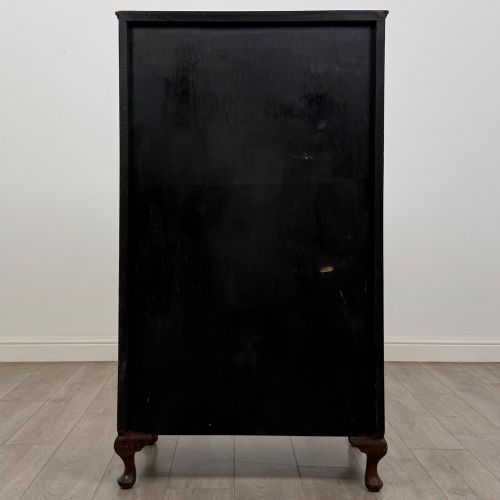 fig 5. An Edwardian burr walnut storage cupboard featuring two top doors with brass strap hinges above two drawers on cabriole legs.