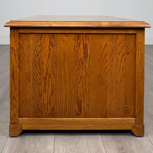 fig 2. A low 20th-century oak chest of drawers featuring five drawers arranged across three tiers with diamond-shaped metal handles.