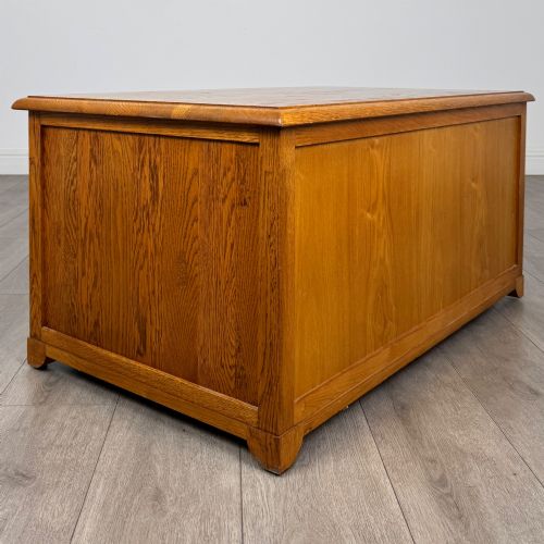 fig 3. A low 20th-century oak chest of drawers featuring five drawers arranged across three tiers with diamond-shaped metal handles.