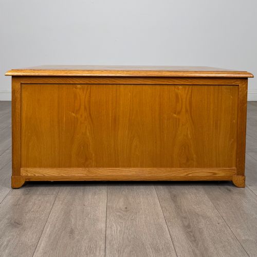 fig 4. A low 20th-century oak chest of drawers featuring five drawers arranged across three tiers with diamond-shaped metal handles.