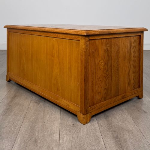 fig 5. A low 20th-century oak chest of drawers featuring five drawers arranged across three tiers with diamond-shaped metal handles.
