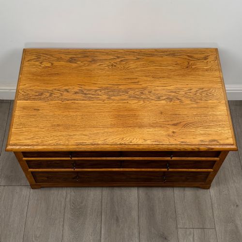 fig 8. A low 20th-century oak chest of drawers featuring five drawers arranged across three tiers with diamond-shaped metal handles.