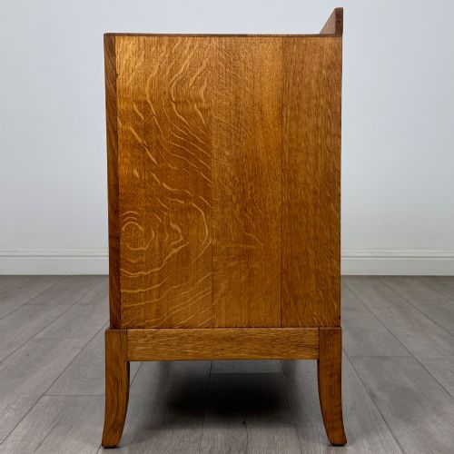 fig 2. A golden oak chest of drawers featuring two short drawers over two long drawers with brass ring handles.