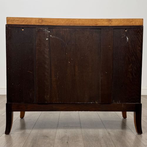 fig 4. A golden oak chest of drawers featuring two short drawers over two long drawers with brass ring handles.