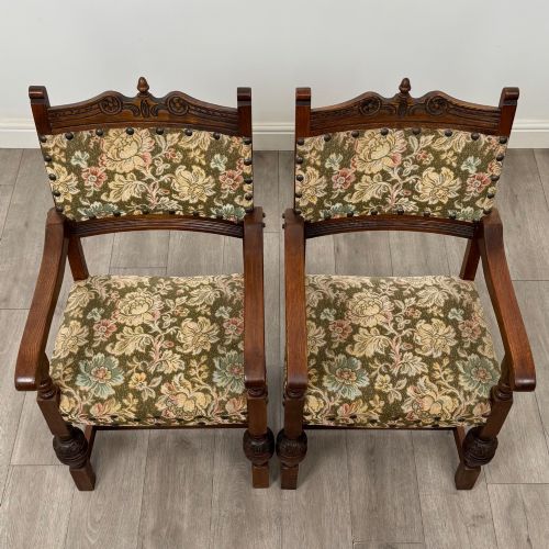 fig 8. A set of six dark oak dining chairs with carved crest rails, floral tapestry upholstered backrests and seats, and turned front legs.
