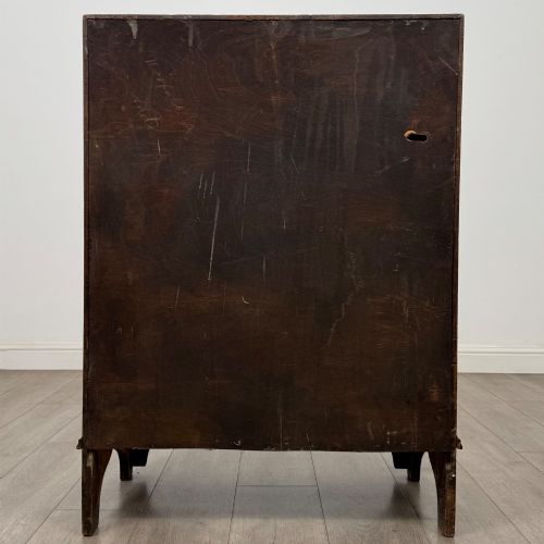fig 5. An Edwardian oak bureau featuring a slanted fall-front lid above three drawers with decorative circular brass drop handles.