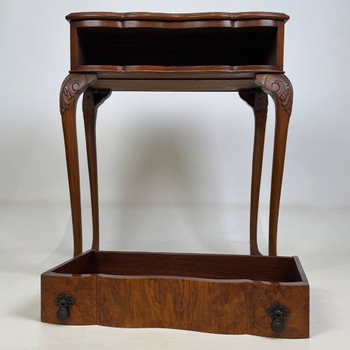 fig 8. An Edwardian side table crafted from warm brown figured walnut featuring a single drawer with ornate brass handles and carved cabriole legs.