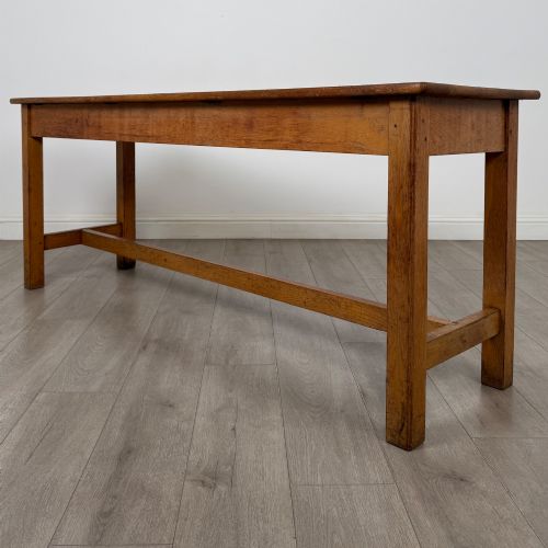 fig 1. A long 20th century oak side table featuring a plain rectangular top, four square legs, and a low central stretcher.