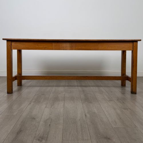 fig 4. A long 20th century oak side table featuring a plain rectangular top, four square legs, and a low central stretcher.