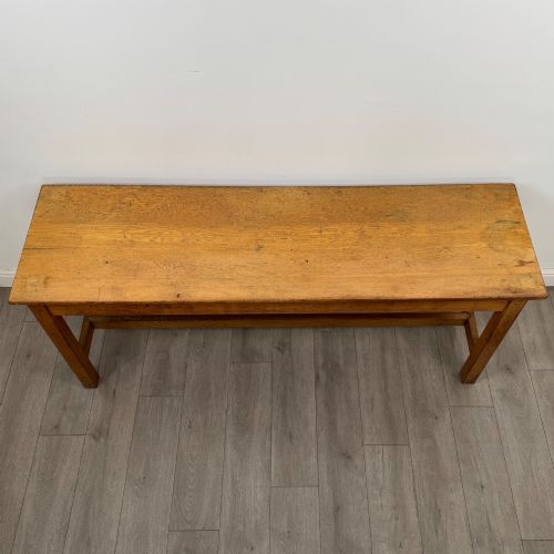 fig 8. A long 20th century oak side table featuring a plain rectangular top, four square legs, and a low central stretcher.