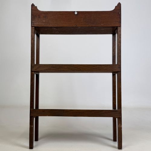 fig 5. An early 20th-century Arts and Crafts solid oak open bookcase featuring three fixed shelves and a shaped gallery backboard with a cutout heart motif.