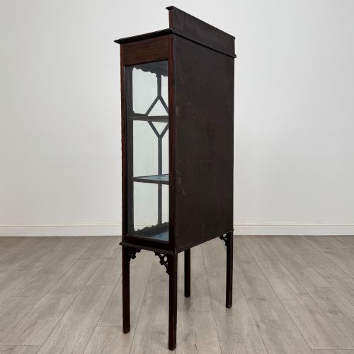 fig 4. A slender Edwardian mahogany glazed display cabinet featuring astragal door bars and a fabric-lined interior raised on square legs.