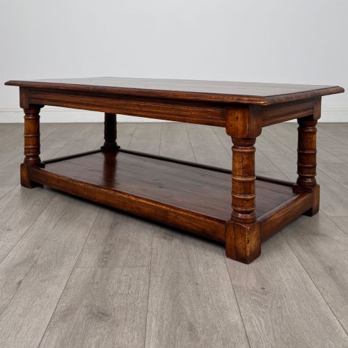 fig 1. A low rectangular dark oak coffee table featuring turned legs and a solid lower shelf.