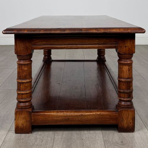 fig 2. A low rectangular dark oak coffee table featuring turned legs and a solid lower shelf.
