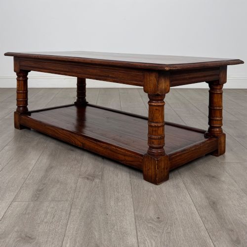 fig 5. A low rectangular dark oak coffee table featuring turned legs and a solid lower shelf.