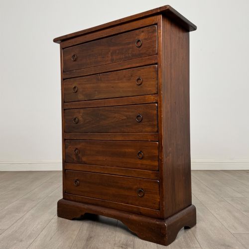 fig 1. A tall dark brown hardwood chest of drawers featuring five horizontal drawers fitted with metal ring pull handles.