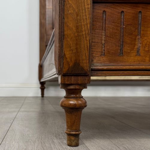fig 7. A 19th-century French oak double bed frame featuring a raised panelled headboard and footboard flanked by fluted posts with turned finials.