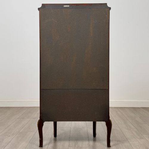 fig 5. A French mahogany display vitrine featuring a curved glass door, red fabric interior lining, floral marquetry lower panel, and brass leg mounts.