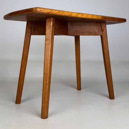 fig 3. A rectangular golden oak coffee table with tapered splayed legs and visible wooden peg joinery.