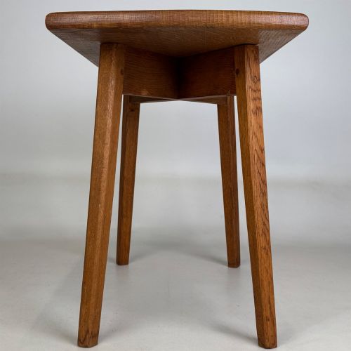 fig 6. A rectangular golden oak coffee table with tapered splayed legs and visible wooden peg joinery.