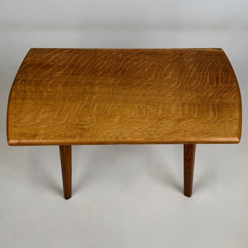 fig 8. A rectangular golden oak coffee table with tapered splayed legs and visible wooden peg joinery.