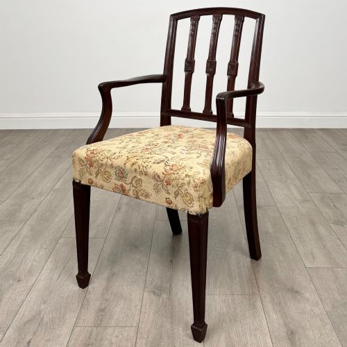 fig 1. A set of six dark mahogany dining chairs featuring carved vertical back splats, square tapered legs, and floral upholstered seats.
