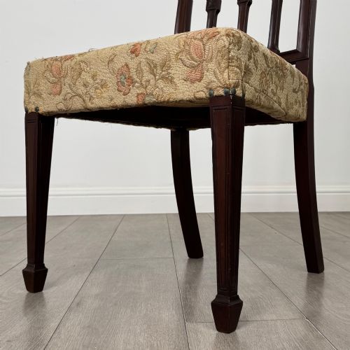 fig 6. A set of six dark mahogany dining chairs featuring carved vertical back splats, square tapered legs, and floral upholstered seats.
