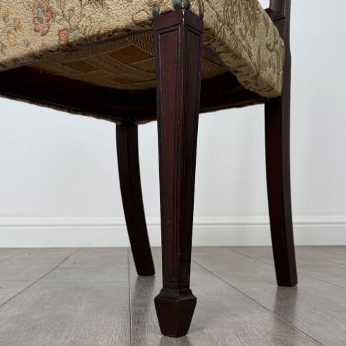 fig 7. A set of six dark mahogany dining chairs featuring carved vertical back splats, square tapered legs, and floral upholstered seats.