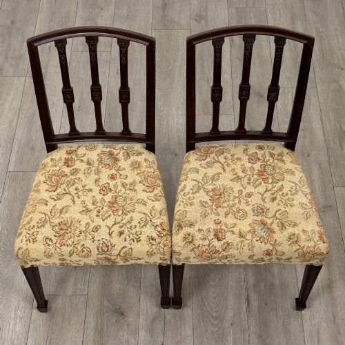 fig 9. A set of six dark mahogany dining chairs featuring carved vertical back splats, square tapered legs, and floral upholstered seats.